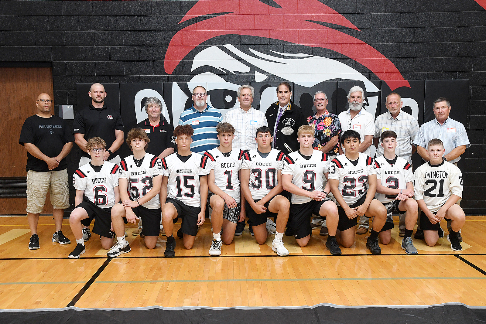 The seniors on the legendary 1973 football team posed with the current football players who were on hand to assist the Covington Alumni. ©Ben Robinson/Color Green Photo